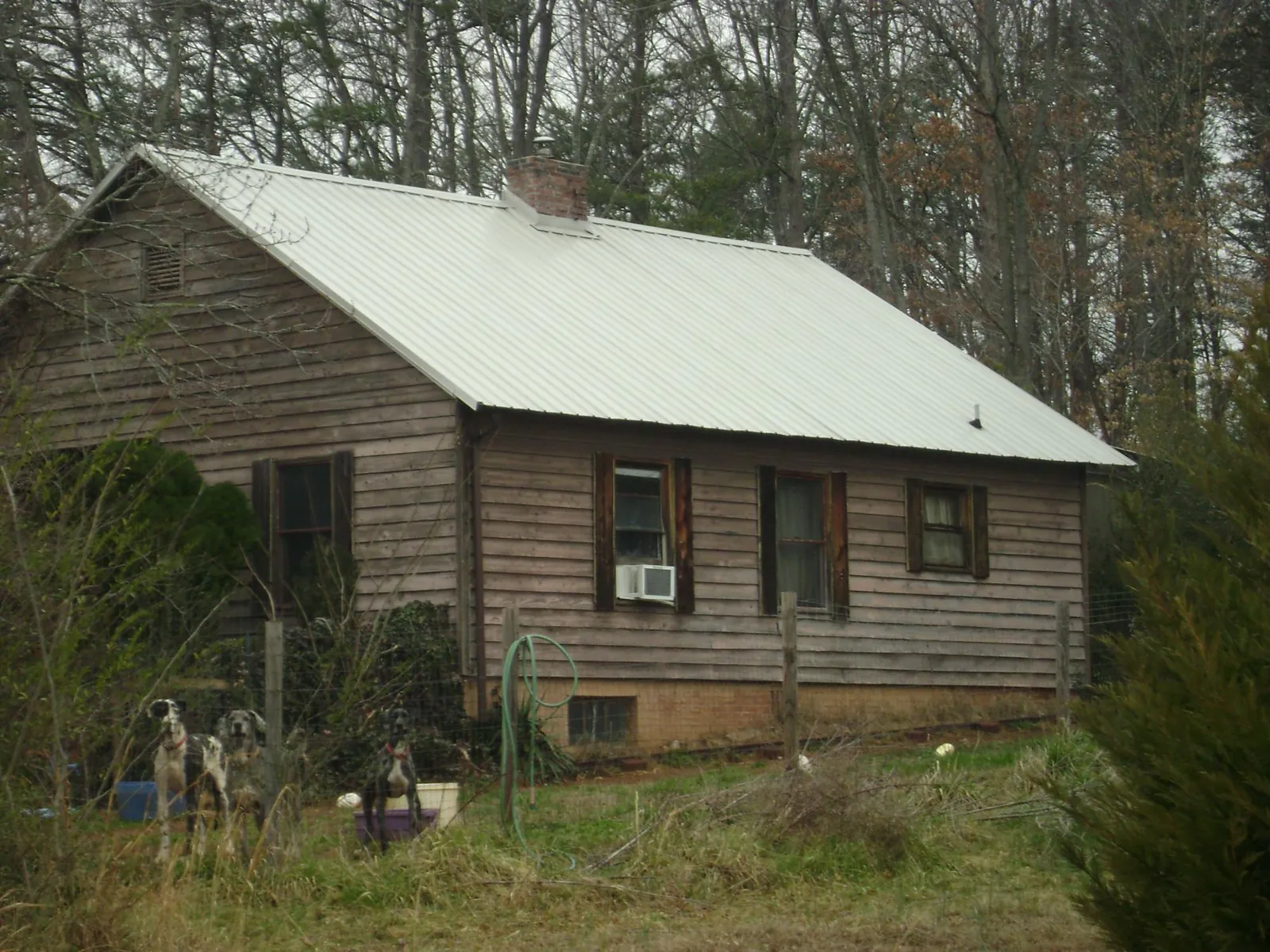 White metal roof on an old wood sided farmhouse, from a Metal Roof Installation job in Bellefontaine